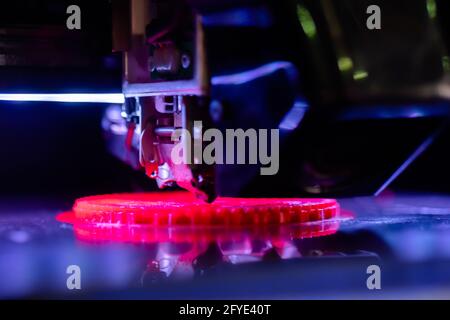 Print head of 3D printer machine printing flat plastic model - close up Stock Photo