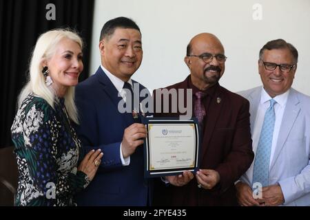 Beverly Hills, California, USA. 26th May, 2021. Princess Karen Cantrell, Joey Zhou, Ike Khamisani, President of the United Nations Association of the United States of America (UNA-USA), Inland Empire, and Carlos Amezcua with a certificate that was given to the Los Angeles Beverly Arts (LABA) from the UNA-USA, Inland Empire, at 'Inextricably Linked' The Art of Jiannan Huang - Vernissage, a private viewing event for artist Jiannan Huang at the Beverly Hilton Hotel in Beverly Hills, California. LABA was founded by TV host Joey Zhou.  Credit: Sheri Determan