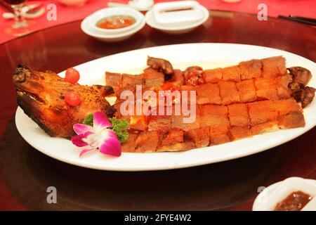 Traditional Hong Kong style bbq roasted suckling pig typically served at a Chinese wedding or special occasion. Stock Photo