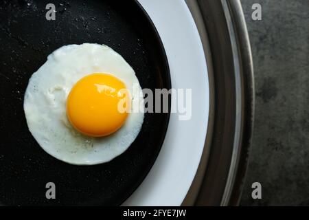 a fried egg in a pan, in 2 plate Stock Photo