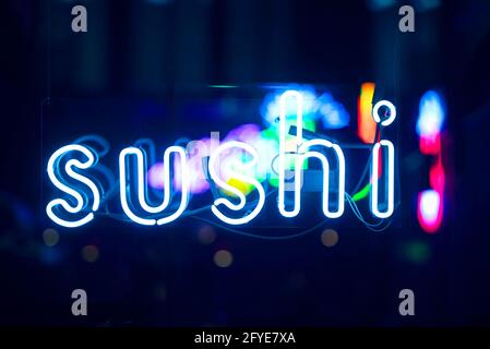 SUSHI glowing neon sign in showcase during night time Stock Photo