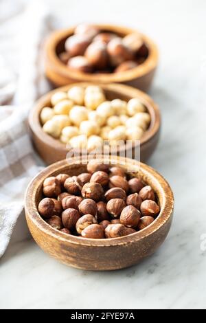 Peeled roasted hazelnut kernels in bowl. Stock Photo