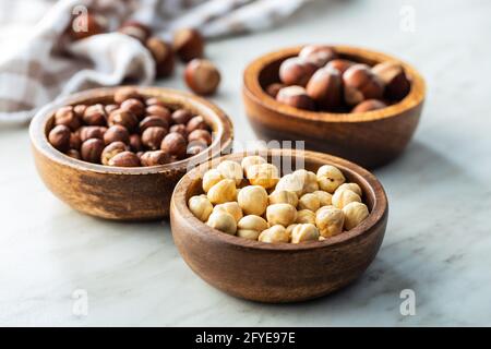 Peeled roasted hazelnut kernels in bowl. Stock Photo