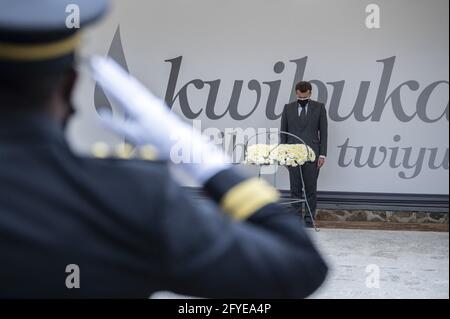 French President Emmanuel Macron readies to lay a wreath in front of 'Kwibuka 27' or âÂ€Â˜remember-unite-renewâÂ€Â™ which marks the 27th anniversary of the start of the 1994 genocide against the Tutsi in Rwanda, during visit to the Kigali Genocide Memorial, where some 250,000 victims of the massacres are buried, in Kigali on May 27, 2021. Photo by Eliot Blondet/ABACAPRESS.COM Stock Photo