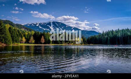 Lost Lake near the village f Whistler, with the ski slopes of Whistler Mountain in the background in British Columbia, Canada Stock Photo