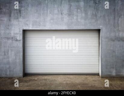 New Modern Garage Door in Unfinish Exterior Concrete Wall Stock Photo