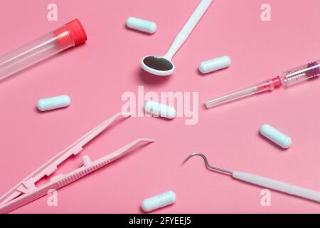 Medical instruments, devices and items on the colored table in the hospital. Syringe, test tube, tweezers. Healthcare, medicine, treatment and doctors concept. High quality photo Stock Photo