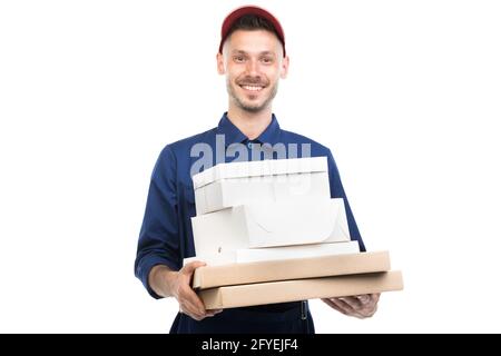 Horizontal medium portrait of handsome young adult Caucasian pizza guy holding boxes looking at camera, white background Stock Photo