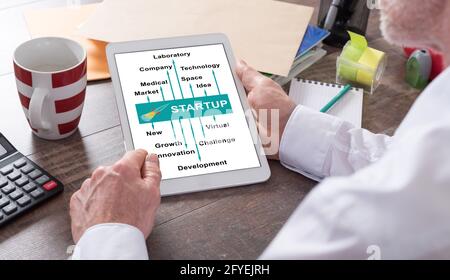 Start up concept shown on a tablet held by a man Stock Photo