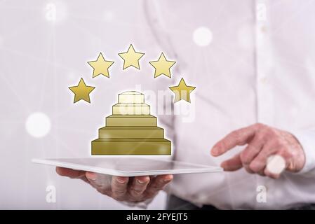 Quality concept above a tablet held by a man in background Stock Photo