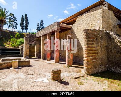 Atrium (central hall) with a central impluvium (water tank) and columns- House of the Relief of Telephus (Casa del Rilievo di Telefo) - Herculaneum ruins, Italy Stock Photo