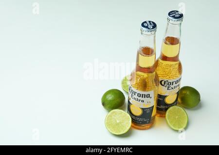 Bottles of Corona Extra and limes on white background Stock Photo