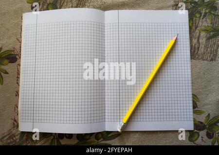 yellow pencil on a notebook Stock Photo