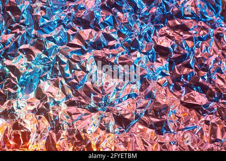 Abstract chrome background with rose gold and vibrant blue color and glossy rough texture. Metall foil paper crumpled. Modern glance futuristic backgr Stock Photo