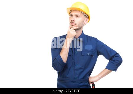 Horizontal medium portrait of modern handsome young adult Caucasian engineer wearing blue uniform thinking about something, white background Stock Photo