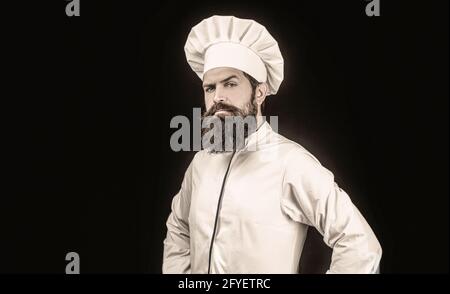 Cook hat. Serious cook in white uniform, chef hat. Portrait of a serious chef cook Stock Photo