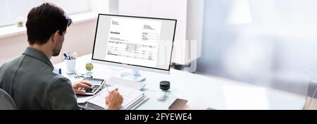 Professional Chartered Accountant Using Electronic Invoice Bill Software Stock Photo