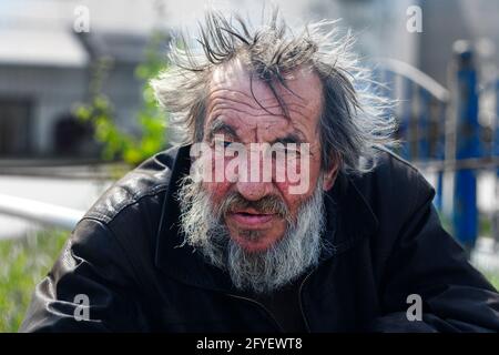 Man hommeless, vagrant beggar on street city. Surgut, Russia - 25, May 2021. Stock Photo
