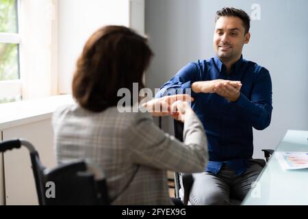 Learning Sign Language For Deaf People In Office Stock Photo