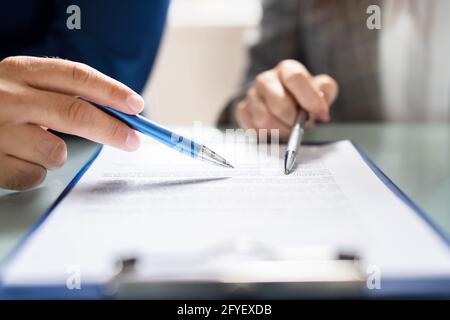 Lawyer Contract Mediation And Review. Two Reading Corporate Document Stock Photo