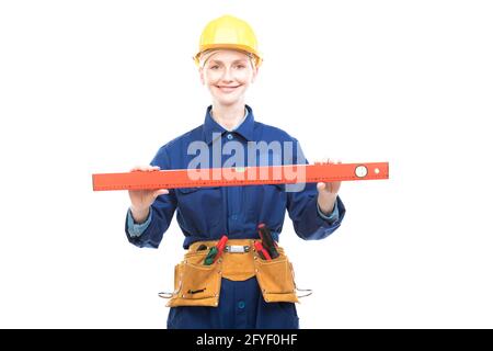 Horizontal medium portrait of modern female construction worker wearing blue uniform using bubble level tool, white background Stock Photo