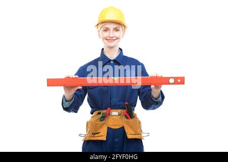 Horizontal medium portrait of modern female construction worker wearing blue uniform using bubble level tool, white background Stock Photo