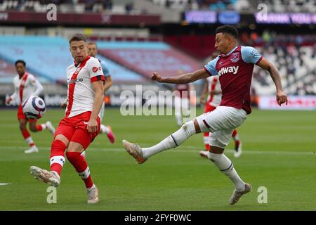 Jesse Lingard of West Ham United and Jan Bednarek of Southampton - West Ham United v Southampton, Premier League, London Stadium, London, UK - 23rd May 2021  Editorial Use Only - DataCo restrictions apply Stock Photo