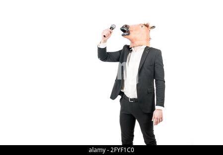 Professional man wear horse head mask in formalwear singing karaoke song, costume party Stock Photo