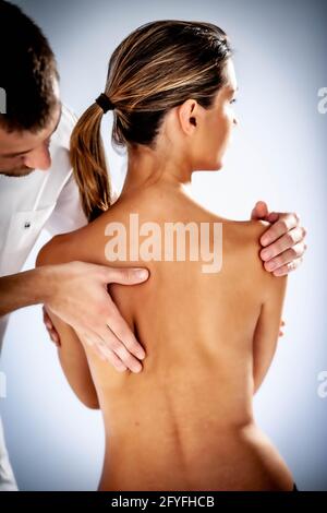 Structural osteopathy session in a woman suffering from neck pain. Stock Photo