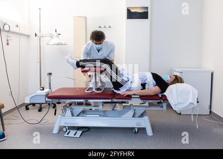 Lumbar traction session performed by a physiotherapist, Limoges hospital, France. Stock Photo