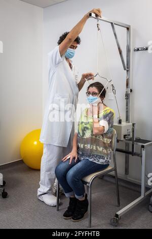 Lumbar traction session performed by a physiotherapist, Limoges hospital, France. Stock Photo