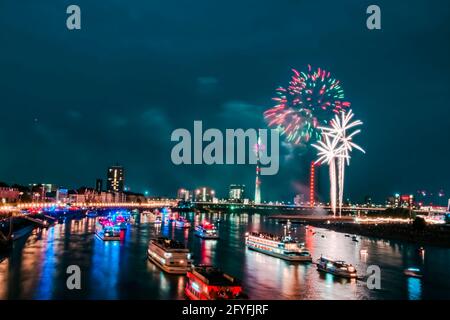 Wonderful firework reflecting in the calm water of the river Rhine. Dusseldorf media harbor. Stock Photo