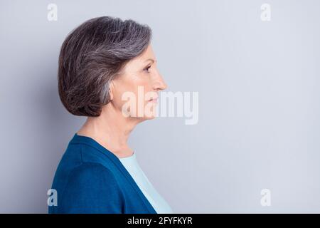 Side profile photo portrait of serious elder woman looking empty space isolated on grey color background Stock Photo