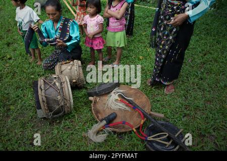 Women getting ready with accessories and musical instruments before a show of 'caci' (Flores Island's traditional whip fight, martial art) in Liang Ndara village, Mbeliling, West Manggarai, Flores, East Nusa Tenggara, Indonesia. Stock Photo