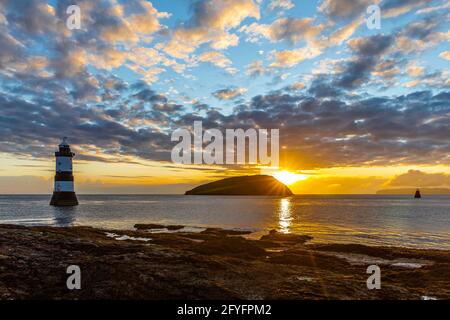 Penmon Lighthouse, Trwyn Du, Puffin Island at sunrise from Penmon Point, Anglesey, Wales. Stock Photo