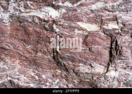 Red white natural stone with rough surface in close-up Stock Photo