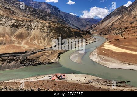 Scenic view of Confluence of Zanskar river from left and Indus rivers from up right - Leh, Ladakh, Jammu and Kashmir, India. Famous tourist spot. Stock Photo