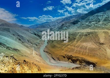 Zanskar river - top view with blue sky with clouds and Himalayan Mountains in the background. Leh, Jammu and Kashmir, Ladakh, India Stock Photo