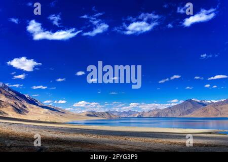 Beautiful blue sky, clouds and mountains at Pangong tso (Lake). It is huge lake in Ladakh, extends from India to Tibet. Leh, Ladakh, Jammu and Kashmir Stock Photo