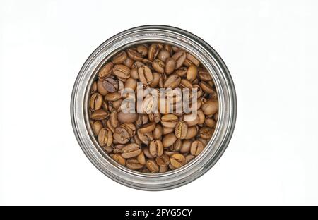 Top view on isolated round glass jar with brown roasted fresh coffee beans, white background Stock Photo