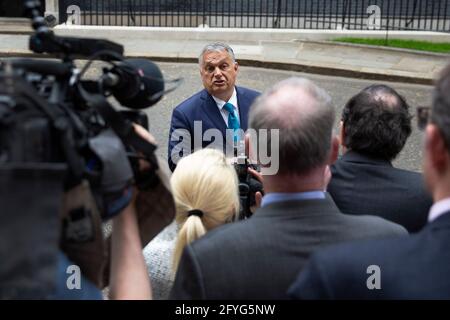 UK Prime Minister Boris Johnson welcomes Hungarian PM Viktor Mihály Orbán to 10 Downing Street on the 28th of May 2021, as he is questioned  by press. Stock Photo