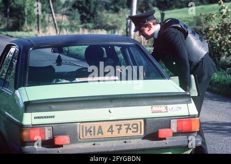 COUNTY TYRONE, UNITED KINGDOM - SEPTEMBER 1980. RUC, Royal Ulster Constabulary, police on vehicle stop and search during the Troubles, Northern Ireland, 1980s Stock Photo