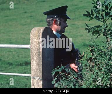 COUNTY TYRONE, UNITED KINGDOM - SEPTEMBER 1980. RUC, Royal Ulster Constabulary, police on vehicle stop and search during the Troubles, Northern Ireland, 1980s Stock Photo