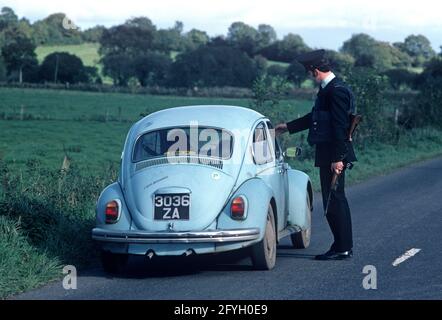 COUNTY TYRONE, UNITED KINGDOM - SEPTEMBER 1980. RUC, Royal Ulster Constabulary, police on vehicle stop and search during the Troubles, Northern Ireland, 1980s Stock Photo