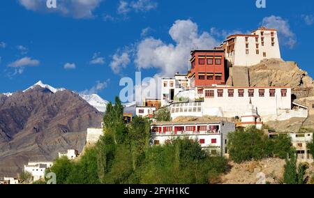 Thiksay monastery with view of Himalayan mountians and blue sky with white clouds in background,Ladakh,Jammu and Kashmir, India Stock Photo