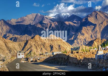 Highway of Leh with rocky mountains and snow peak with blue sky in background, Leh, Ladakh, Jammu and Kashmir, India Stock Photo