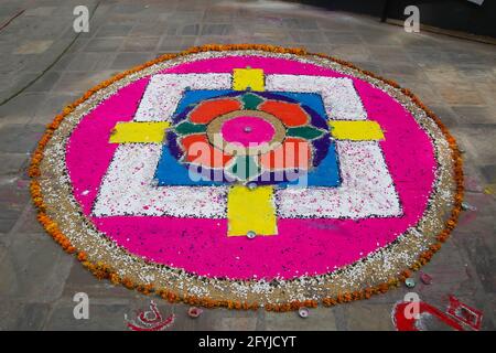 A colourful mandala on the street in Kathmandu, Nepal. It is made from rice, sand and flowers. Stock Photo