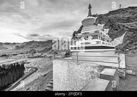 Thiksay monastery with view of Himalayan mountians and blue sky with white clouds in background,Ladakh,Jammu and Kashmir, India. Black and white image Stock Photo