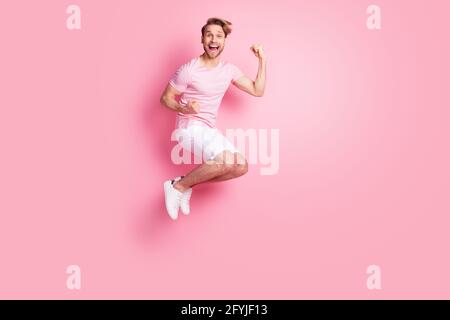 Full size photo of astonished person fists up open mouth celebrate success isolated on pink color background Stock Photo
