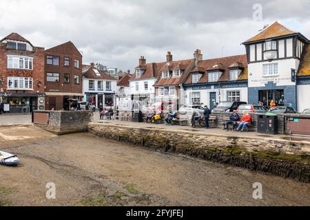 People sat relaxing at the Quay in Lymington, Hampshire, England, UK Stock Photo